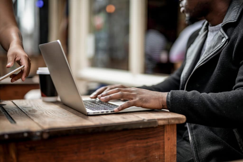 Businessman,Working,Remotely,From,A,Cafe