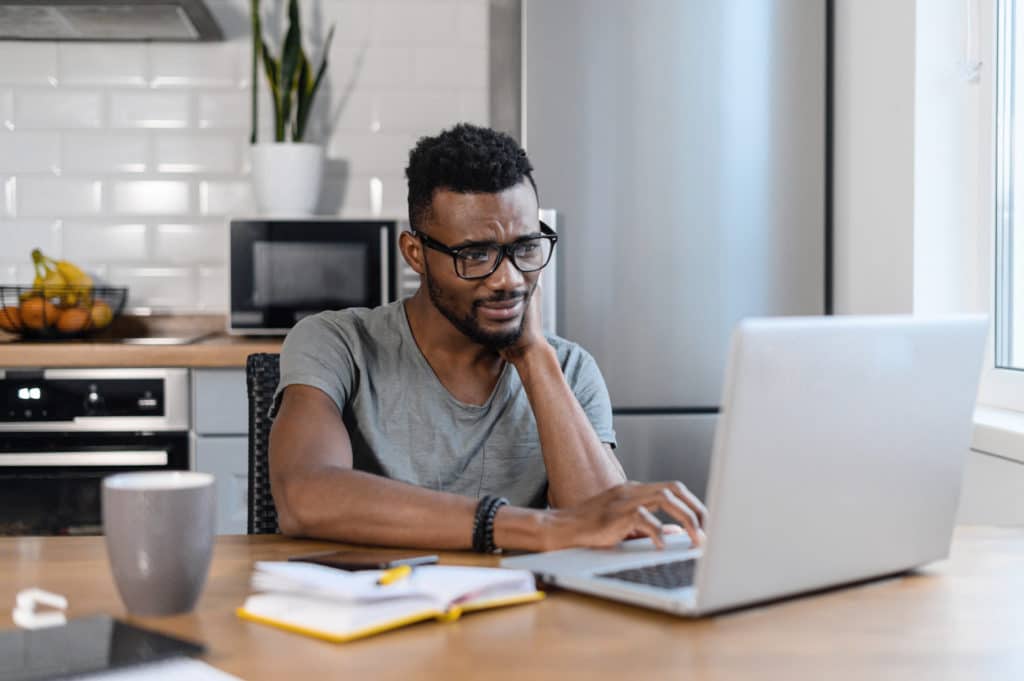 Tired,African,American,Male,Employee,Sit,At,The,Table,In