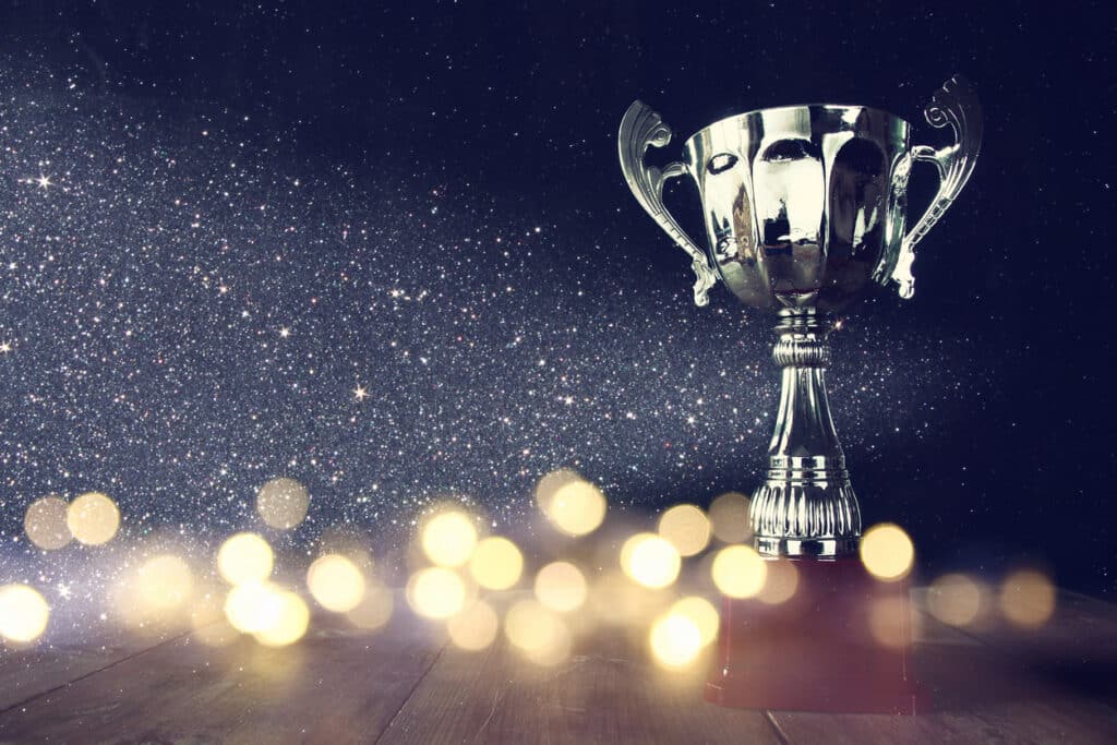 low key image of trophy over wooden table
