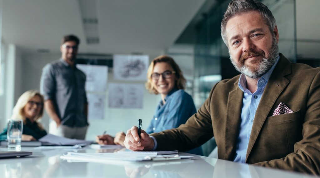 businesspeople looking at camera with smile
