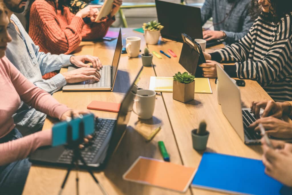young business people working inside modern coworking office focus on center man hands