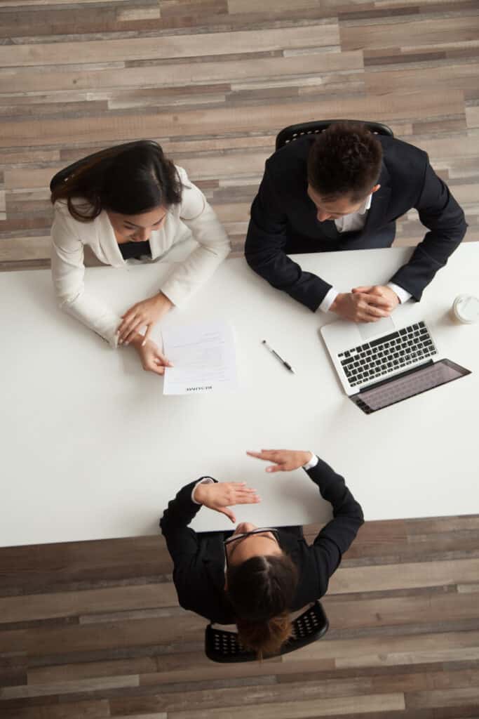 female vacancy candidate answering questions at job interview, top view