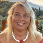 Sarah Hamilton-Gill smiles at the camera from her location in Corfu